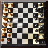 Y07. Folding chess board and wooden pieces.